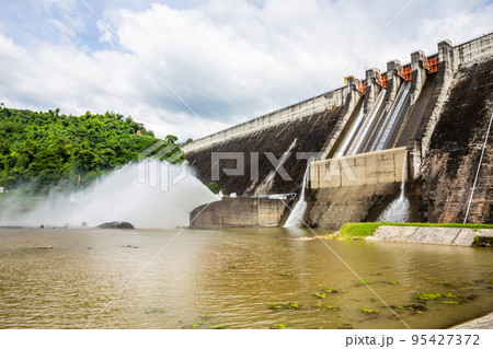 Khun Dan Prakan Chon Dam is made of large concrete. It is releasing water from the dam to reduce the amount of water from rain in Nakhon Nayok, Thailand. Khun Dan Prakan Chon Dam is made of large concrete. It is releasing water from the dam to reduce the amount of water from rain in Nakhon Nayok, Thailand. 95427372