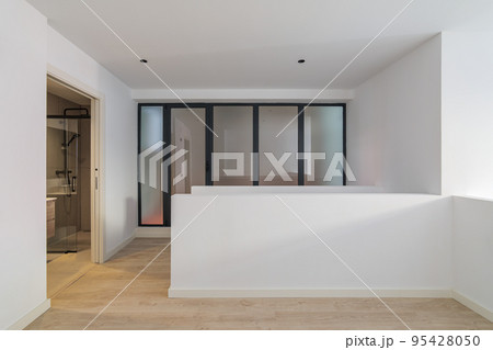 Interior of empty flat with doorway to bathroom. White and clean room in refurbished apartment 95428050