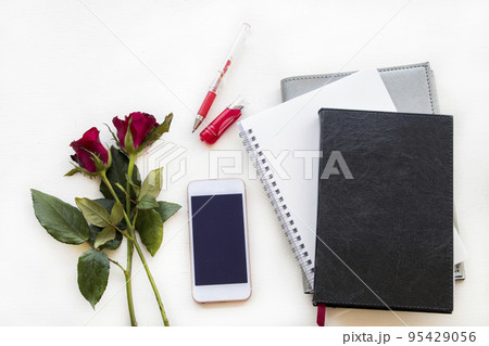 notebook planner, mobile for business work with rose flowers  95429056
