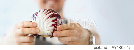 Male blogger with organic and purple vegetable in kitchen, healthy vegetarian food blog Male blogger with organic and purple vegetable in kitchen, healthy vegetarian food blog 95430577