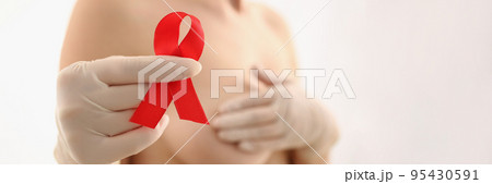 Woman hold red ribbon in hand wear glove, fight breast cancer, message for female 95430591