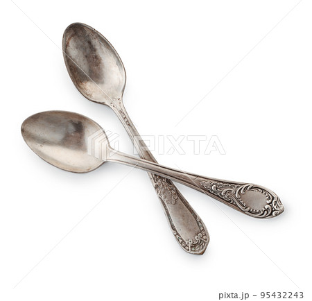 Top view of two old silver teaspoons 95432243