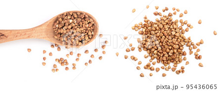 buckwheat grain in wooden spoon isolated on white background close up. Top view 95436065