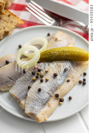 Marinated herring fish on plate. 95439383