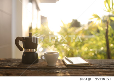Black moka pot and white coffee cup and notebook Black moka pot and white coffee cup and notebook 95440151