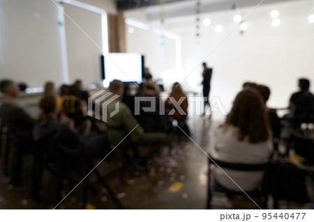 Blurred background of the business conference, one man on the stage, presentation of the project, public talk. High quality photo 95440477