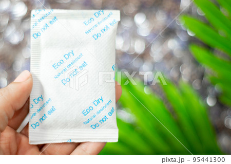 Desiccant silica on the pack. Closeup view. packet of silica gel buried in silica crystals, Written do not eat 95441300