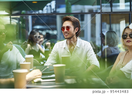 young asian adult friends gathering relaxing in outdoor coffee shop 95443483