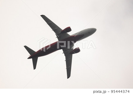 Russian regional jet plane in bright sky 95444374