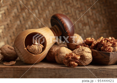 Walnuts on an old wooden table. 95444421