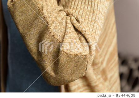 Patch on a man wool sweater. Concept needlework, recycling and thrift. Selective focus Patch on a man wool sweater. Concept needlework, recycling and thrift. Selective focus 95444609