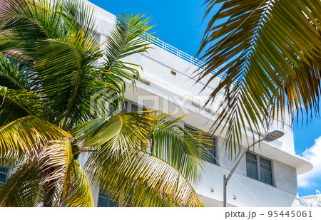 Closeup of typical colorful Art Deco architecture with tropical palm tree on Ocean Drive in South Beach, Miami, Florida, USA 95445061