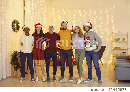 Portrait of happy multiracial friends who gathered together at home to celebrate Christmas. Portrait of happy multiracial friends who gathered together at home to celebrate Christmas. 95446873