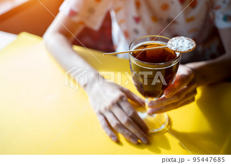 female drink brown cube libre cocktail with cola, brandy, rum or whiskey in cafe 95447685