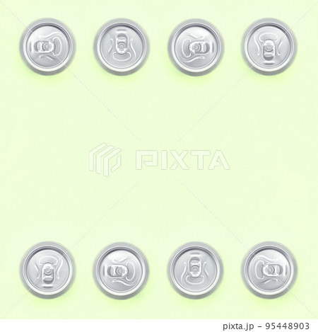 Frame of a many metallic beer cans on texture background of fashion pastel lime color paper 95448903