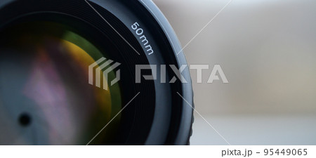 Fragment of a portrait lens for a modern SLR camera. A photograph of a wide-aperture lens with a focal length of 50mm Fragment of a portrait lens for a modern SLR camera. A photograph of a wide-aperture lens with a focal length of 50mm 95449065
