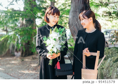 お葬式で笑顔で故人を送る遺族 95451579