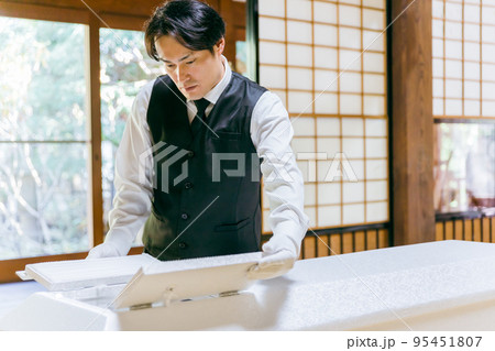 棺の窓を開ける葬儀スタッフ・納棺師の男性 棺の窓を開ける葬儀スタッフ・納棺師の男性 95451807