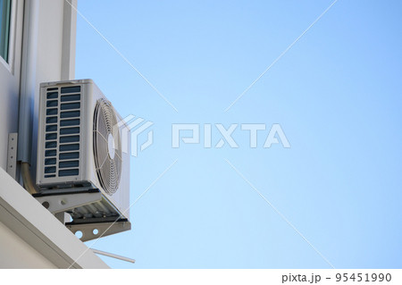 Air condition outdoor unit compressor install outside the house with blue sky Air condition outdoor unit compressor install outside the house with blue sky 95451990