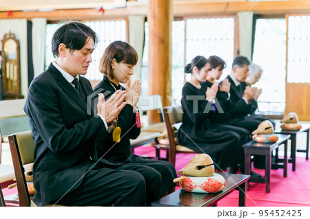 お葬式に参列する遺族（合掌） 95452425