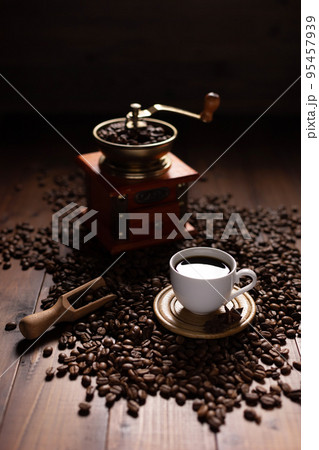 Cup of coffee and beans at wood table. Homemade coffee at table 95457939