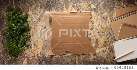 Cardboard torn edge and brown ripped paper on chipboard plywood background. Recycling concept Cardboard torn edge and brown ripped paper on chipboard plywood background. Recycling concept 95458132