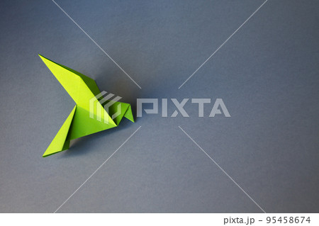 Green paper dove origami isolated on a grey background 95458674