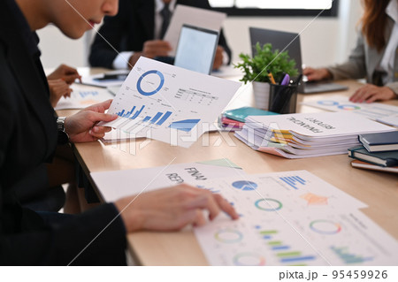 Cropped image of focused businessman analyzing statistics, financial graphs charts at meeting table 95459926