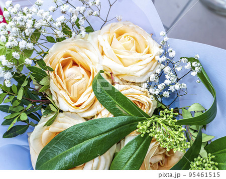 A festive bouquet of cream rose garden flowers. 95461515