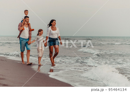 Family gatherings and socializing on the beach at sunset. The family walks along the sandy beach. Selective focus  95464134