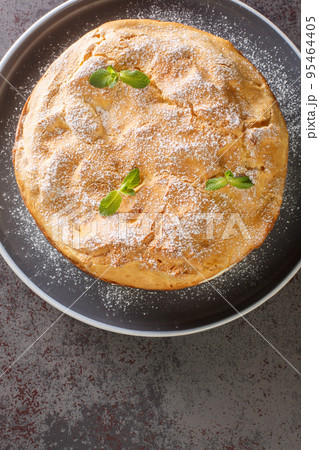 Traditional Polish cake Karpatka of choux pastry dough and custard cream closeup on the plate. Vertical top view 95464405