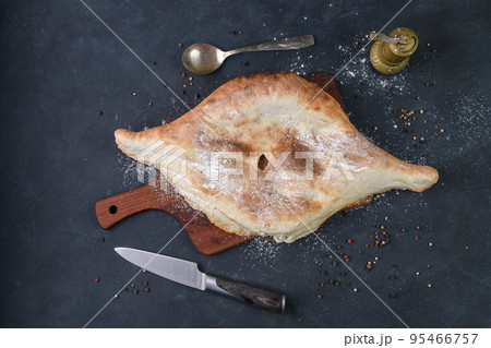 Georgian bread lavash on wooden board on dark rustic background, top view 95466757