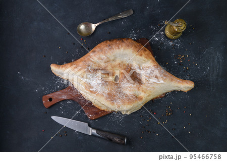 Georgian bread lavash on wooden board on dark rustic background, top view 95466758