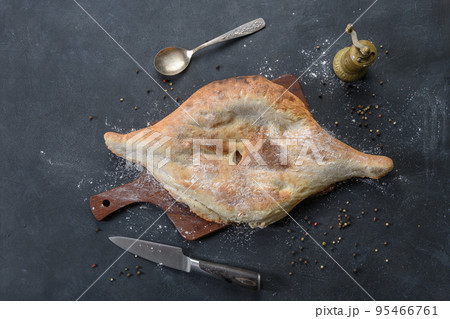 Georgian bread lavash on wooden board on dark rustic background, top view 95466761