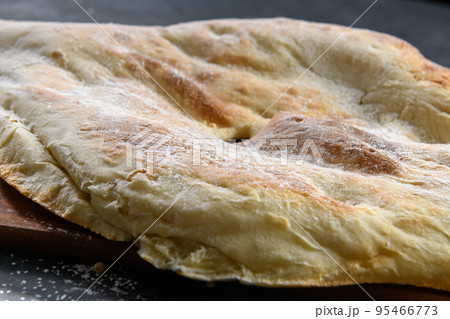 Georgian bread lavash on dark rustic background, close up Georgian bread lavash on dark rustic background, close up 95466773