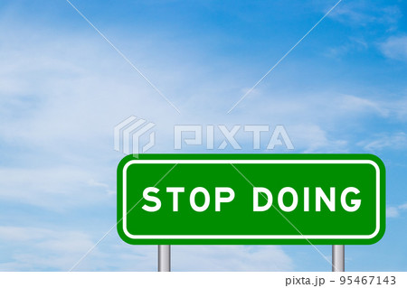 Green color transportation sign with word stop doing on blue sky with white cloud background Green color transportation sign with word stop doing on blue sky with white cloud background 95467143