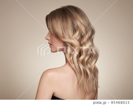 Blonde woman with long curly hair Blonde woman with long curly hair 95468015