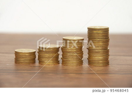 Golden coins stacked on wooden table. Wealth and business growth concept. 95468045