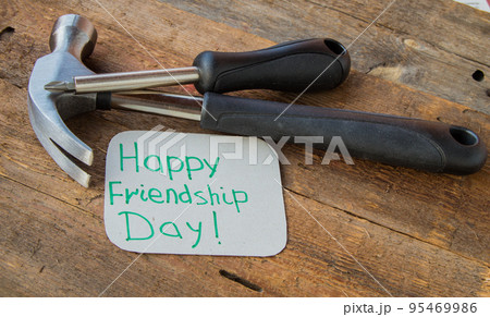 Tags happy friendship day and tools on the old wooden background 95469986