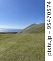 海が見える芝生の山 95470574