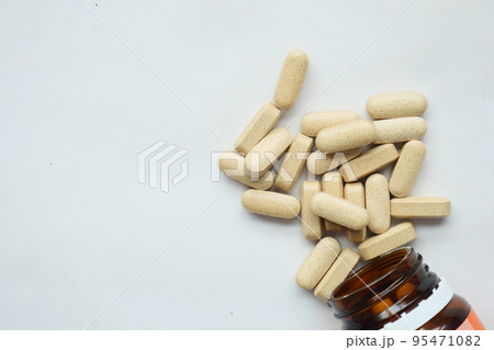 Vitamin C pill supplement on white background  95471082