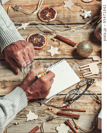 Elderly senior hands writing letter to santa or christmas shoppi 95471842