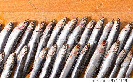 Pickled anchovies on wooden background 95473599
