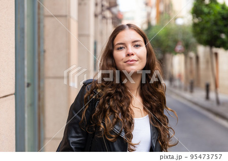 Cheerful attractive female walking on street outdoor Cheerful attractive female walking on street outdoor 95473757