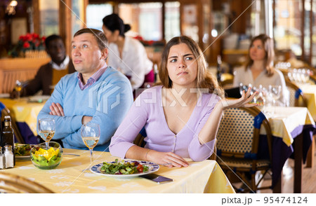 Quarreled visitors female and male at restaurant on celebrate Quarreled visitors female and male at restaurant on celebrate 95474124
