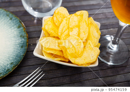 Potato chips served with glass of beer Potato chips served with glass of beer 95474159
