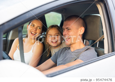 Portrait of happy family of three in car salon 95474476