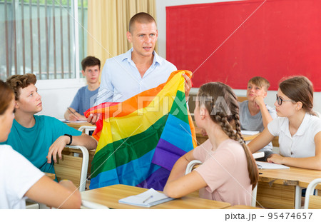 Teacher discussing with teenage students about LGBT in classroom 95474657