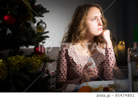 Sad woman celebrating New Year 95474801