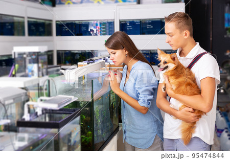 Woman and boy with interest looking at small aquarium 95474844